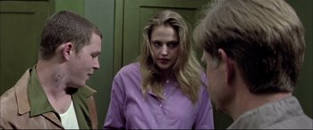 Movie still from “The Cooler” (2003), directed by Wayne Kramer – A woman standing next to two other men; Medium shot, Over the shoulder angle