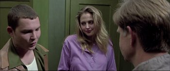 Movie still from “The Cooler” (2003), directed by Wayne Kramer – A woman in a purple shirt is looking at the camera; Close Up shot, Over the shoulder angle