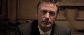 Movie still from “The Cooler” (2003), directed by Wayne Kramer – A person wearing a suit and tie; Close Up shot, Low angle