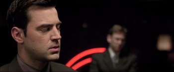 Movie still from “The Cooler” (2003), directed by Wayne Kramer – A man in a suit and tie in front of another man in a suit and tie; Close Up shot, Over the shoulder angle