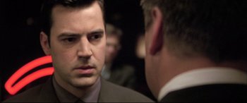 Movie still from “The Cooler” (2003), directed by Wayne Kramer – A man in a suit and tie talking to another man in a suit and tie; Close Up shot, Over the shoulder angle