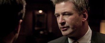 Movie still from “The Cooler” (2003), directed by Wayne Kramer – A person wearing a suit and tie; Close Up shot, Over the shoulder angle