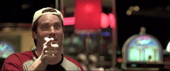 Movie still from “The Cooler” (2003), directed by Wayne Kramer – A man is taking a selfie in front of a neon sign; Close Up shot, Low angle