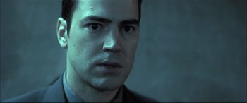 Movie still from “The Cooler” (2003), directed by Wayne Kramer – A person wearing a suit and tie; Close Up shot, Low angle
