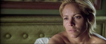 Movie still from “The Cooler” (2003), directed by Wayne Kramer – A person sitting on a couch; Close Up shot, Low angle