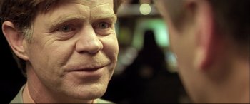 Movie still from “The Cooler” (2003), directed by Wayne Kramer – An old man with a strange look on his face; Close Up shot, Over the shoulder angle