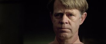 Movie still from “The Cooler” (2003), directed by Wayne Kramer – An older man is looking at the camera; Close Up shot, Over the shoulder angle