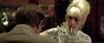 Movie still from “The Cooler” (2003), directed by Wayne Kramer – A man and a woman sitting at a table smoking cigarettes; Close Up shot, Over the shoulder angle