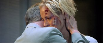 Movie still from “The Cooler” (2003), directed by Wayne Kramer – A man and a woman with bandaids on their faces; Close Up shot, Overhead angle