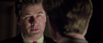 Movie still from “The Cooler” (2003), directed by Wayne Kramer – A person wearing a suit and tie; Close Up shot, Over the shoulder angle