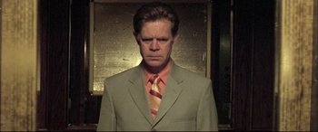 Movie still from “The Cooler” (2003), directed by Wayne Kramer – A man wearing a suit and tie in front of a mirror; Close Up shot, Low angle