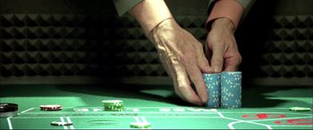 Movie still from “The Cooler” (2003), directed by Wayne Kramer – A person playing a game of craps on a green table; Extreme Close Up shot, Overhead angle