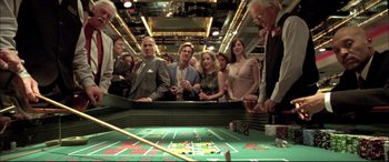 Movie still from “The Cooler” (2003), directed by Wayne Kramer – A group of people standing in front of a craps table; Wide shot, High angle