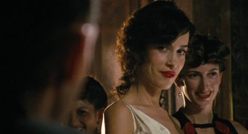 Movie still from “The Counterfeiters” (2007), directed by Stefan Ruzowitzky – A woman in a white dress with red lipstick; Close Up shot, Over the shoulder angle