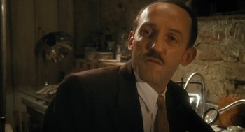 Movie still from “The Counterfeiters” (2007), directed by Stefan Ruzowitzky – A person wearing a suit and tie; Close Up shot, Low angle