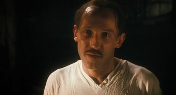 Movie still from “The Counterfeiters” (2007), directed by Stefan Ruzowitzky – A person wearing a white shirt; Close Up shot, Low angle
