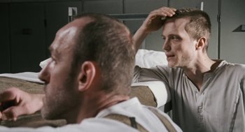 Movie still from “The Counterfeiters” (2007), directed by Stefan Ruzowitzky – A man is looking in the mirror while another man is brushing his hair; Close Up shot, Over the shoulder angle
