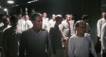 Movie still from “The Counterfeiters” (2007), directed by Stefan Ruzowitzky – A group of men standing next to each other in white shirts; Wide shot, High angle