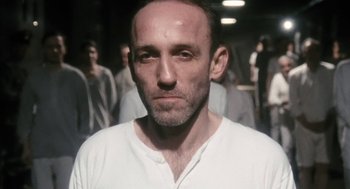 Movie still from “The Counterfeiters” (2007), directed by Stefan Ruzowitzky – A person wearing a white shirt; Close Up shot, Low angle