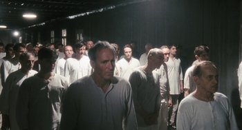 Movie still from “The Counterfeiters” (2007), directed by Stefan Ruzowitzky – A large group of men in white shirts standing in a room; Wide shot, High angle