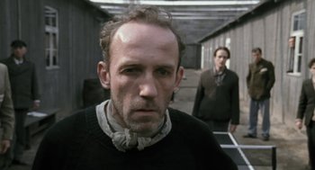 Movie still from “The Counterfeiters” (2007), directed by Stefan Ruzowitzky – A man in a black shirt and a man in a black shirt; Close Up shot, Low angle