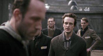 Movie still from “The Counterfeiters” (2007), directed by Stefan Ruzowitzky – A group of men standing next to each other; Close Up shot, Over the shoulder angle