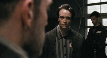 Movie still from “The Counterfeiters” (2007), directed by Stefan Ruzowitzky – A man in striped shirt looking at himself in a mirror; Close Up shot, Over the shoulder angle