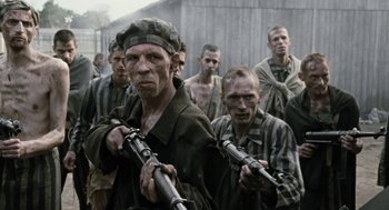 Movie still from “The Counterfeiters” (2007), directed by Stefan Ruzowitzky – A group of men holding guns in front of each other; Medium shot, Over the shoulder angle