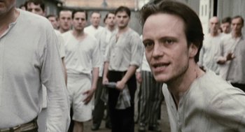 Movie still from “The Counterfeiters” (2007), directed by Stefan Ruzowitzky – A group of men standing next to each other in white shirts; Close Up shot, Over the shoulder angle