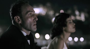 Movie still from “The Counterfeiters” (2007), directed by Stefan Ruzowitzky – A man and a woman are looking into the night sky; Close Up shot, Over the shoulder angle