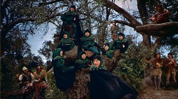 Movie still from “The Court Jester” (1955), directed by Melvin Frank – A group of people dressed in green costumes; Wide shot, Low angle