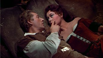 Movie still from “The Court Jester” (1955), directed by Melvin Frank – A man and a woman laying on the ground; Medium shot, Overhead angle