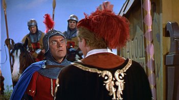 Movie still from “The Court Jester” (1955), directed by Melvin Frank – Two men in medieval garb talking to each other; Medium shot, Over the shoulder angle