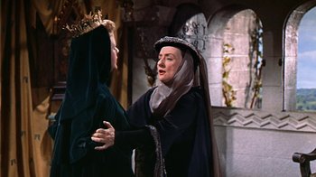 Movie still from “The Court Jester” (1955), directed by Melvin Frank – Two women dressed in medieval clothing talking to each other; Medium shot, Over the shoulder angle
