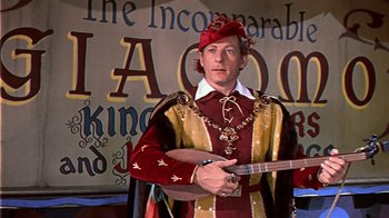 Movie still from “The Court Jester” (1955), directed by Melvin Frank – A man dressed in medieval clothing holding an instrument; Medium shot, Low angle