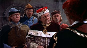 Movie still from “The Court Jester” (1955), directed by Melvin Frank – A group of men in medieval garb standing next to each other; Medium shot, Over the shoulder angle
