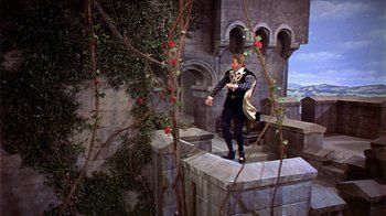Movie still from “The Court Jester” (1955), directed by Melvin Frank – A man standing on top of a stone wall; Wide shot, High angle