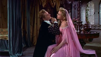 Movie still from “The Court Jester” (1955), directed by Melvin Frank – A man and a woman dressed in a pink dress; Medium shot, High angle