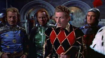 Movie still from “The Court Jester” (1955), directed by Melvin Frank – A man in a black and red jacket and a man in a green and black jacket; Medium shot, Low angle