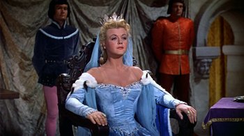 Movie still from “The Court Jester” (1955), directed by Melvin Frank – A woman wearing a blue dress and a crown; Medium shot, Low angle