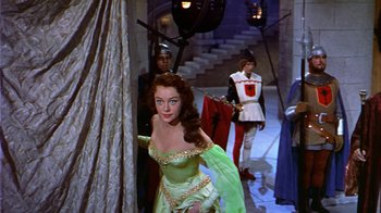 Movie still from “The Court Jester” (1955), directed by Melvin Frank – A woman dressed as a princess in front of two other men; Medium shot, Over the shoulder angle