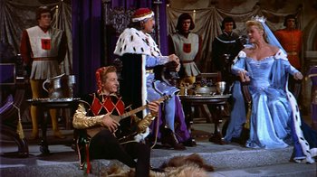 Movie still from “The Court Jester” (1955), directed by Melvin Frank – A group of people dressed in medieval costumes; Wide shot, High angle