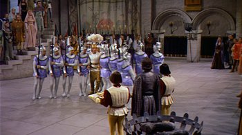 Movie still from “The Court Jester” (1955), directed by Melvin Frank – A group of people dressed in costumes in front of an audience; Extreme Wide shot, High angle