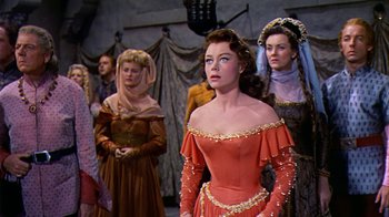 Movie still from “The Court Jester” (1955), directed by Melvin Frank – A group of people in medieval costumes standing in a room; Medium shot, Low angle