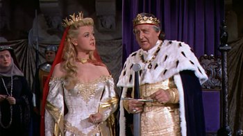 Movie still from “The Court Jester” (1955), directed by Melvin Frank – A man and a woman dressed as a king and queen; Medium shot, High angle