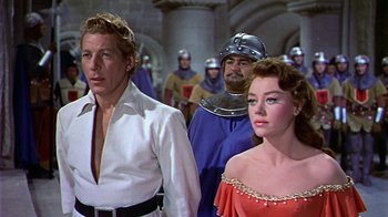 Movie still from “The Court Jester” (1955), directed by Melvin Frank – A man and a woman standing next to each other in front of a crowd; Medium shot, Low angle