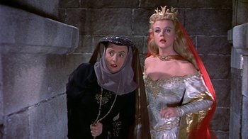 Movie still from “The Court Jester” (1955), directed by Melvin Frank – Two women dressed in medieval costumes in a stone room; Medium shot, Low angle