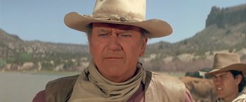 Movie still from “The Cowboys” (1972), directed by Mark Rydell – An older man wearing a cowboy hat and a scarf; Close Up shot, Low angle