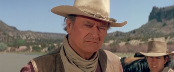 Movie still from “The Cowboys” (1972), directed by Mark Rydell – An older man wearing a cowboy hat and a neck scarf; Close Up shot, Low angle