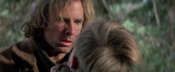 Movie still from “The Cowboys” (1972), directed by Mark Rydell – A person holding a child; Close Up shot, Over the shoulder angle